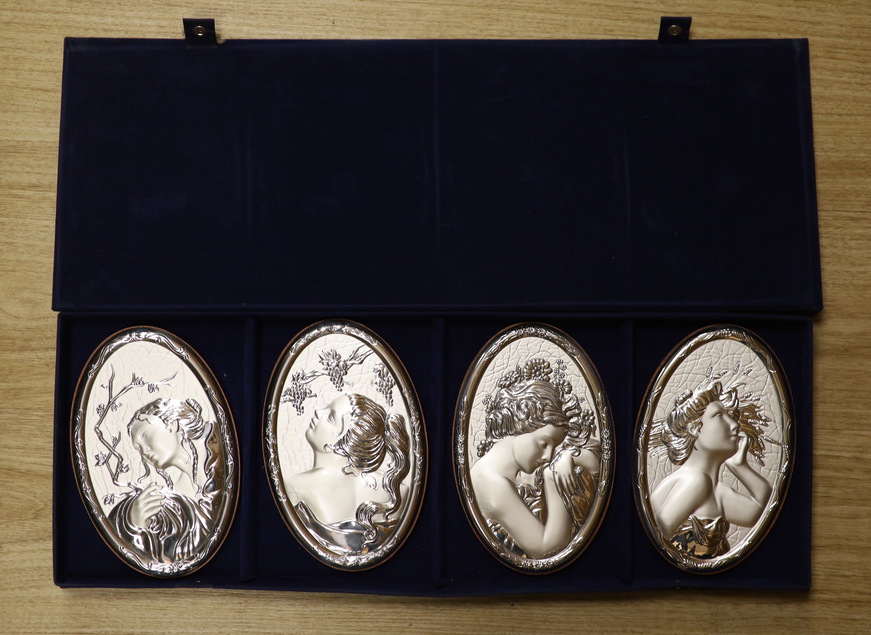A cased set of four modern Italian repousse 850 white metal mounted 'The Four Seasons' wall plaques, 20.4cm.